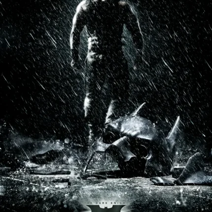 Black and white poster of a figure in the rain beside a broken bat mask
