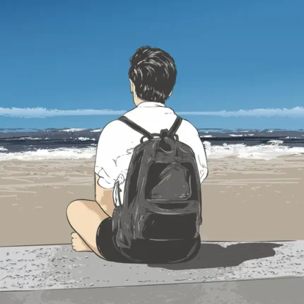 Person with a black backpack sitting on a beach looking at the sea under a blue sky