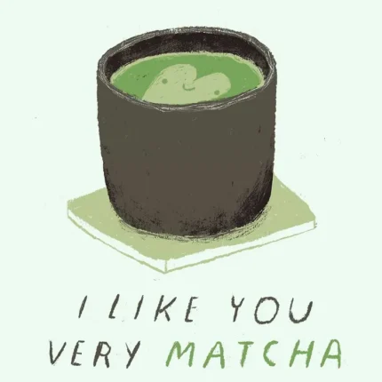 Cup of green matcha tea on a coaster with the text I like you very matcha