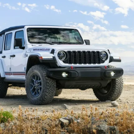 White Jeep Wrangler on a dry rocky trail under a blue sky
