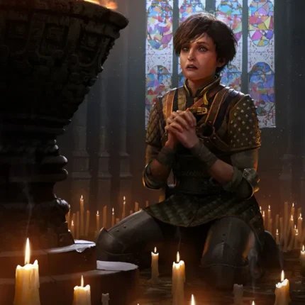 Young woman kneeling in prayer among candles before a stained-glass window
