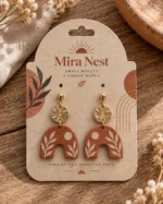Kraft earring card with leaf lines holding terracotta arch-shaped clay earrings