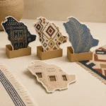 Kingdom shaped cards on kraft stands with Sadu patterns, palm leaf and window art