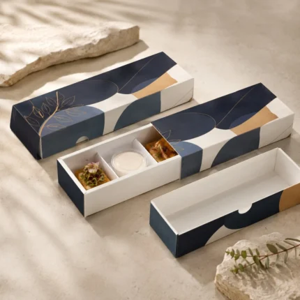 Long navy and ochre drawer boxes with an open three-compartment tray